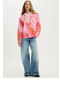 Woman wearing pink tie dye hoodie and blue jeans