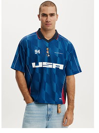 Man wearing blue oversized sports jersey with number 84