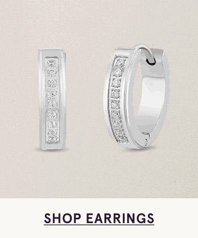 Pair of silver-toned huggies, each set with vertical row of round diamonds. Click here to shop earrings
