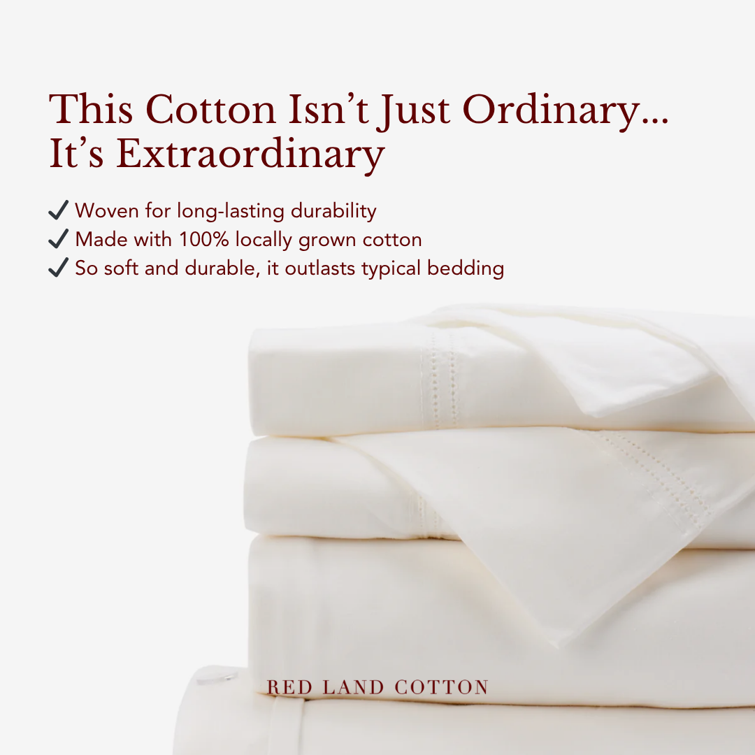 A stack of folded white cotton bed sheets with promotional text.