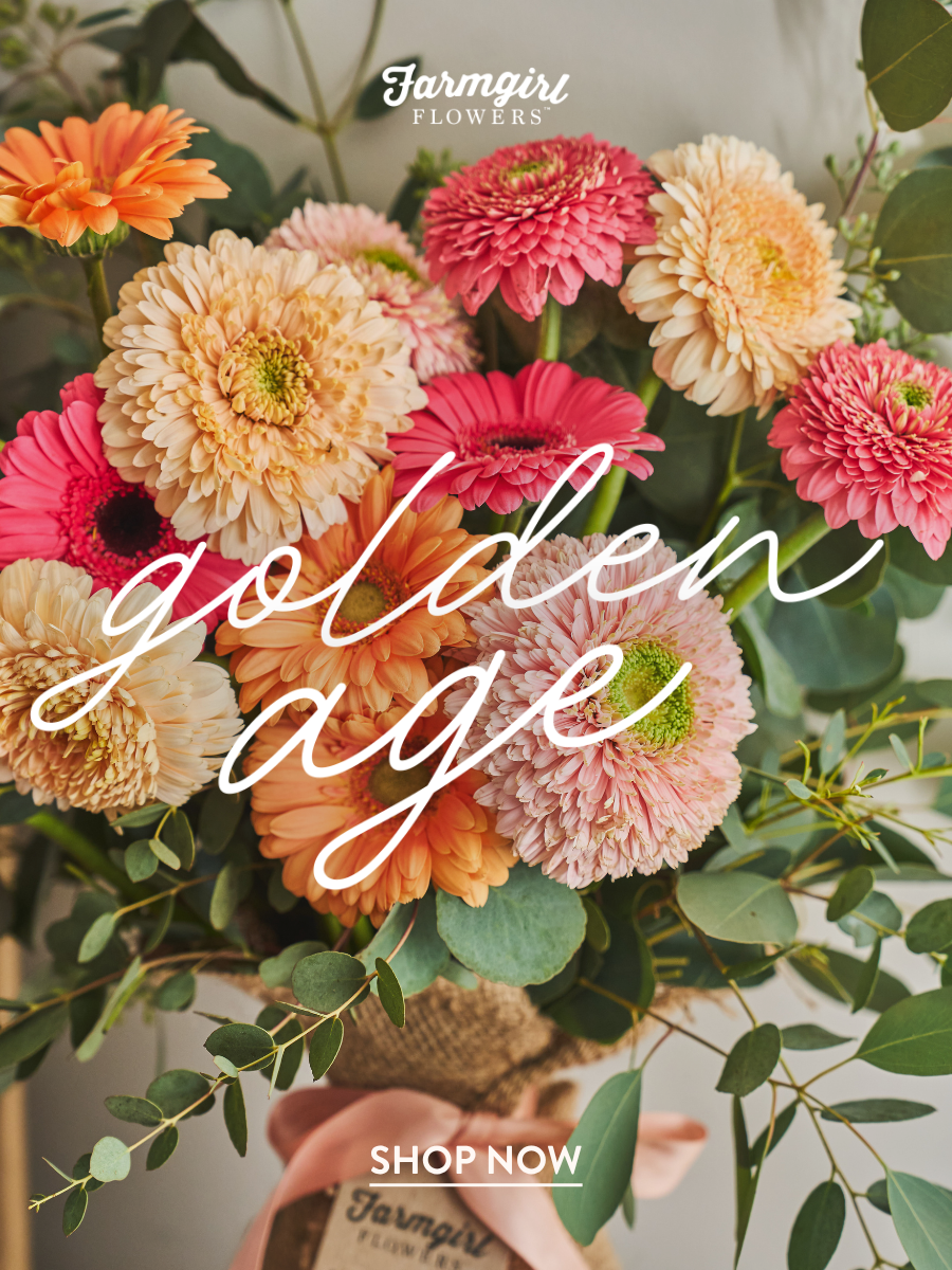 Farmgirl Flowers campaign image featuring a colorful bouquet with orange, peach, pink, cream, and pale blush flowers with greenery. White script text reads “golden age,” with the Farmgirl Flowers logo near the top and a “Shop the Season” button near the bottom.
