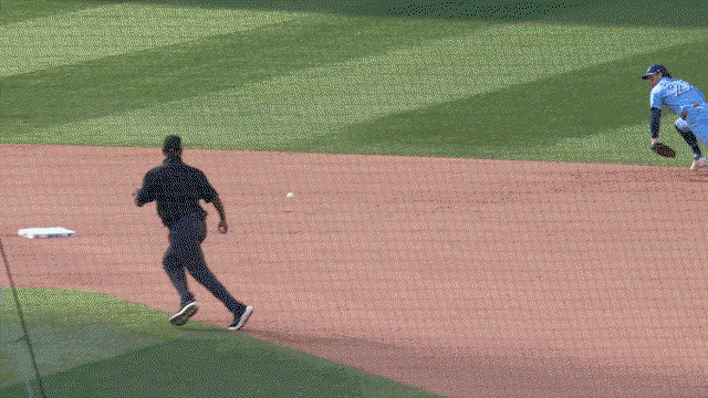 An animated gif of Ernie Clement making a diving stop and throw from his knees