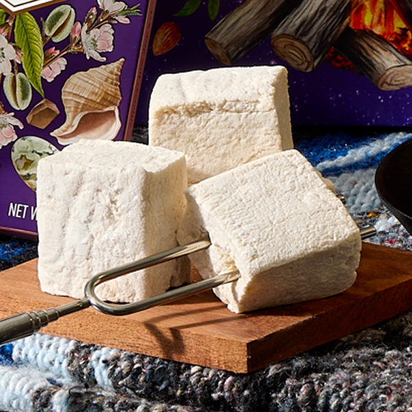 Three Vosges vanilla marshmallows sit on a plate.