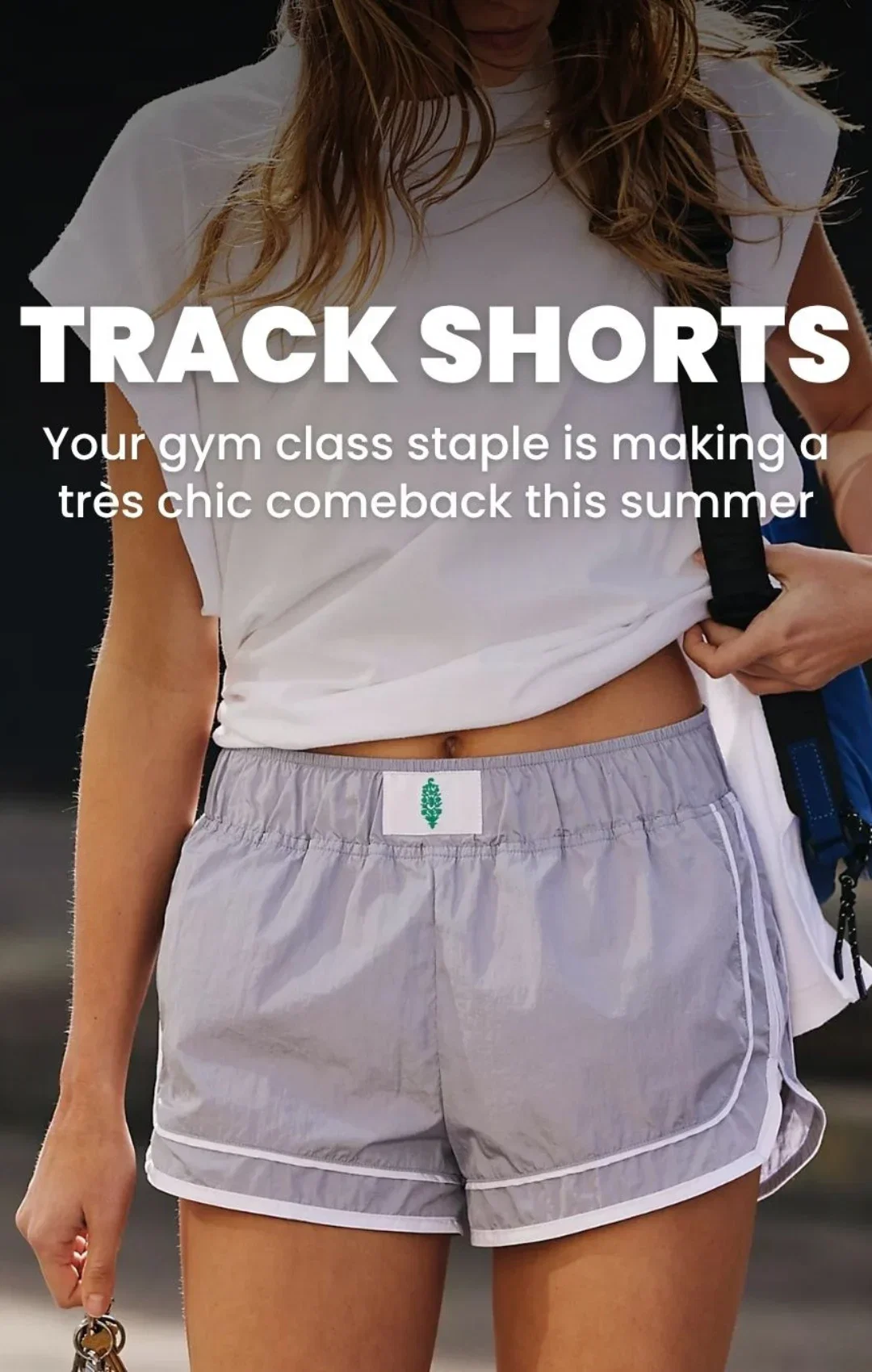 woman wears light gray track shorts and white t-shirt