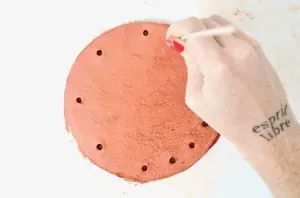 Poke holes in a clay circle to copy this better-than-Anthro coffee table accent