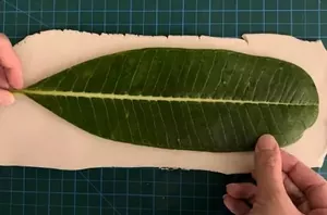 She starts by pressing a leaf into a piece of clay and ends up with a beautiful bedroom accessory