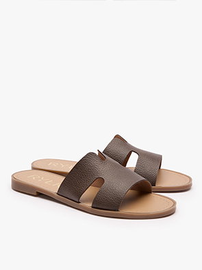 Brown leather slide sandals with open toe design on white background.