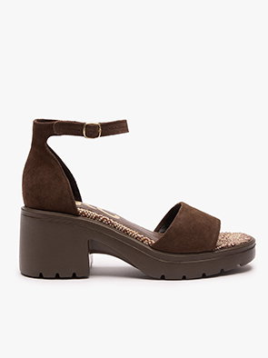 Brown suede block heel sandal with ankle strap and textured sole on white background.