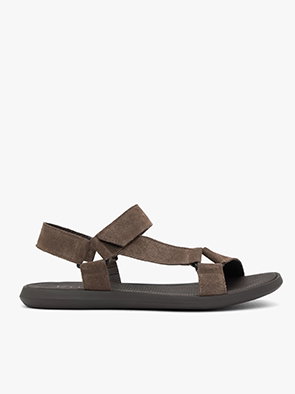 Brown suede sandal with adjustable straps and black sole on white background.