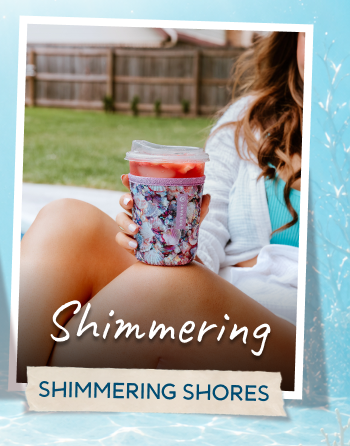 Woman holding a shimmering seashell-themed Ocean Treasures tumbler outdoors.