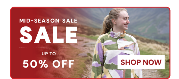 MID SEASON SALE: UP TO 50% OFF. SHOP NOW. A woman wearing Patagonia Women's Lightweight Synchilla Snap-T Pullover in Cream/Green.