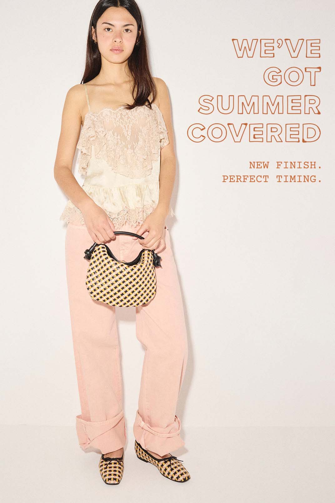 woman in lace top and pink pants with woven bag and matching ballet flats