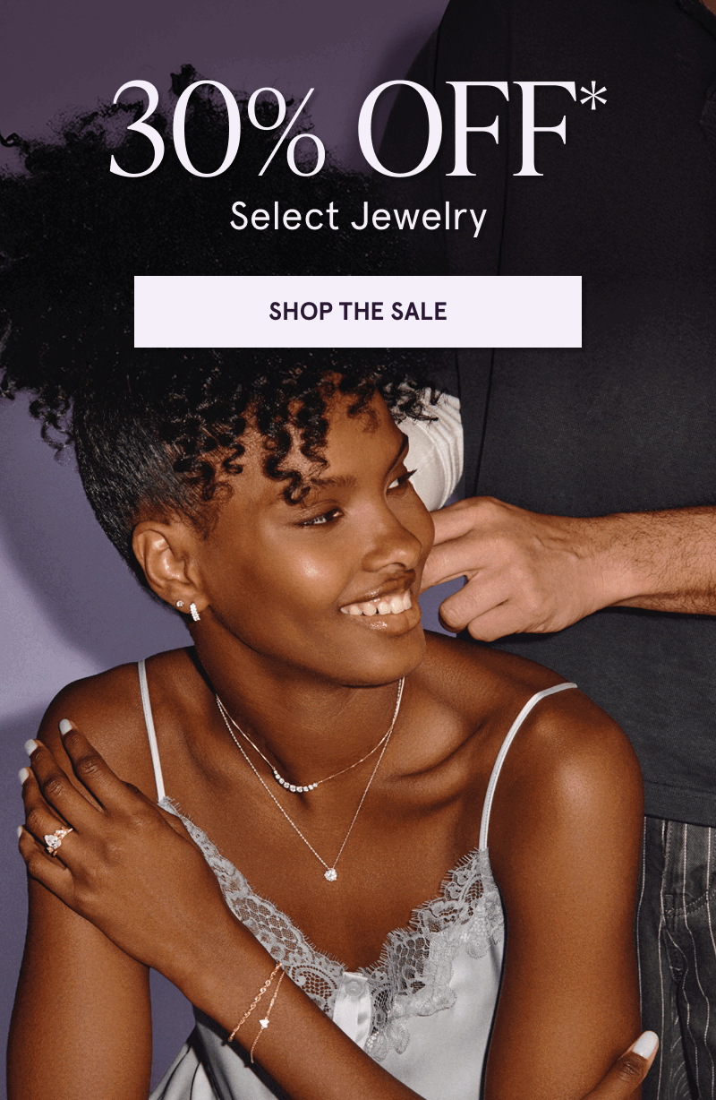 Model in dainty gold-set diamond jewelry, featuring pendants & diamond ring. 30% OFF Select Jewelry. Click here to shop now