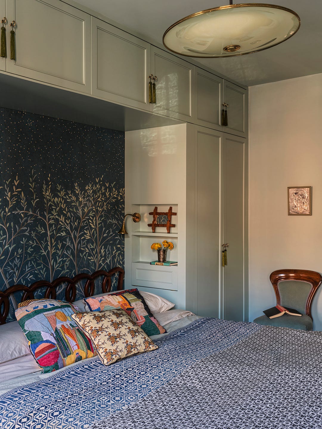 Bed sitting beneath built-in wall storage Bed sitting beneath built-in wall storage