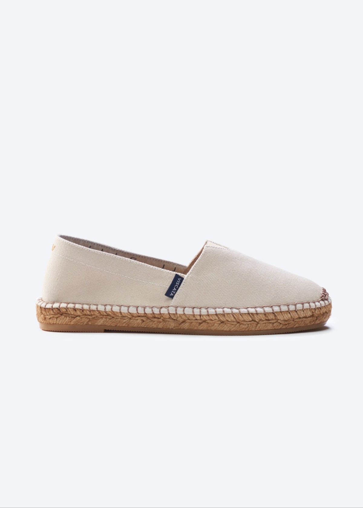 Beige Barceloneta canvas slip-on espadrille flats with a closed rounded toe and minimal natural jute sole, handmade in Spain by Viscata