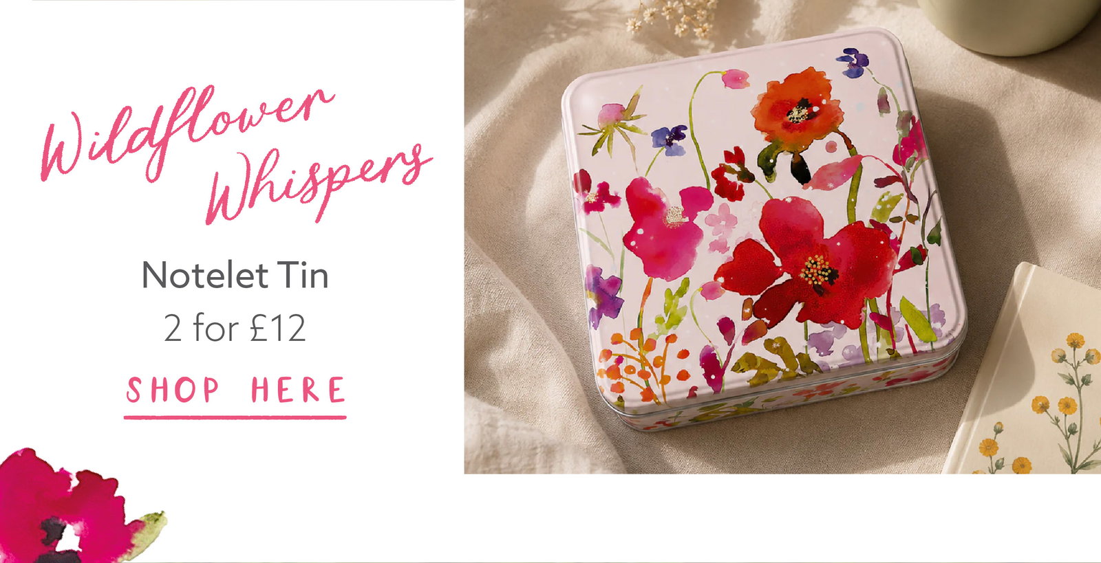 Wildflower Whispers notelet tin featuring colourful wildflower artwork, styled on soft fabric with stationery accessories.