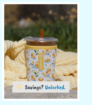 Patterned reusable cup sleeve with iced beverage outdoors.