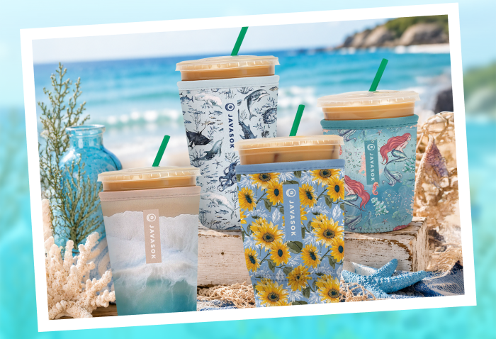Reusable cup sleeves with iced drinks on a beach.