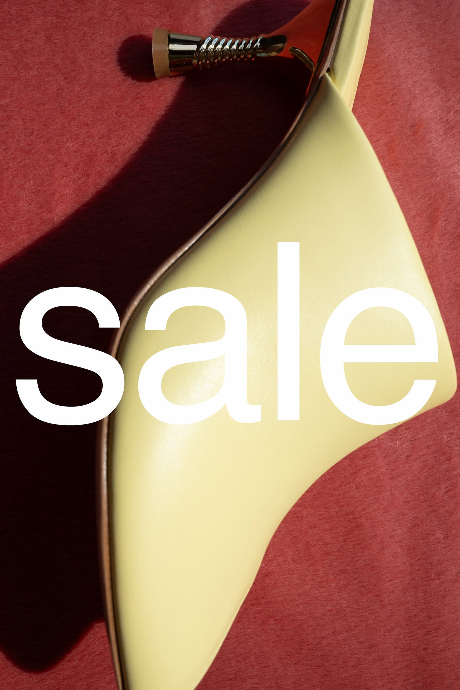 Sale campaign image by Studio Amelia featuring a pale yellow slingback heel on a deep red background.