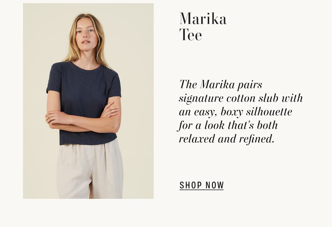 Image of model wearing marika top in navy. Text reads: Marika Tee. The Marika pairs signature cotton slub with an easy, boxy silhouette for a look that's both relaxed and refined.