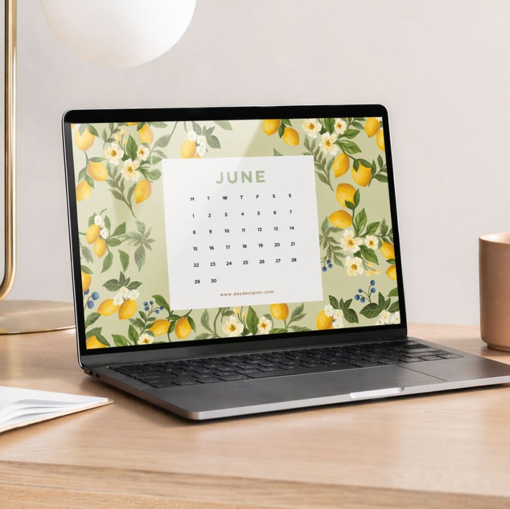 june 2026 digital wallpaper, shown with lemon floral sage background on laptop, coffee cup, lamp, book, wood table