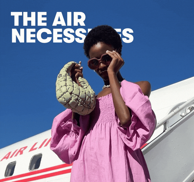 A GIF of a woman walking off a plane. She wears a pink dress, statement jewellery, a small bag, and sunglasses.