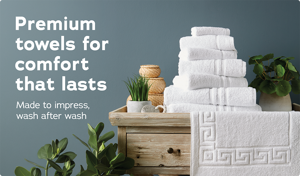 Premium Towels, comfort that lasts. An image showing a pile of Essential Capri Towels White. Shop now >