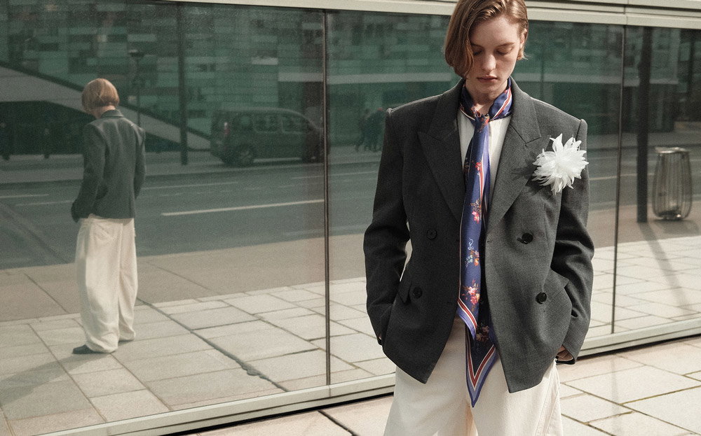 A close up of a woman wearing Grey Double Breasted Flower Blazer