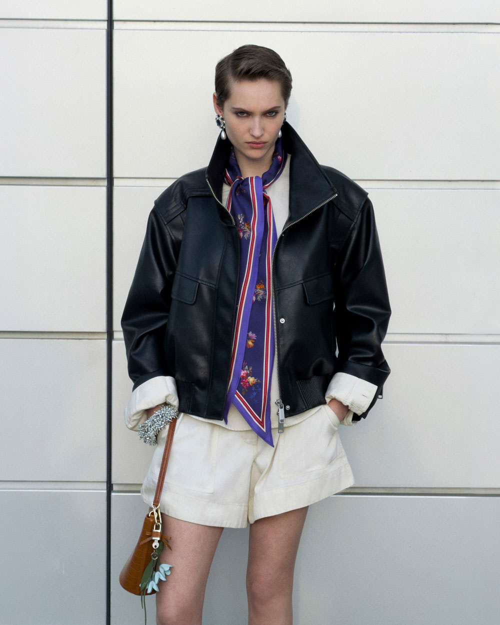 A picture of a woman wearing the Black Faux Leather Bomber Jacket