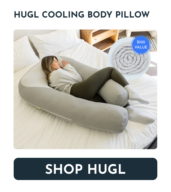 A person sleeping on a bed with a large, gray cooling body pillow.