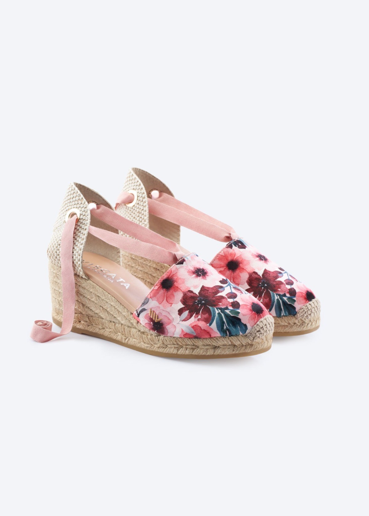 Red Flowers Escala canvas lace-up espadrille wedges with a floral print, closed rounded toe, wraparound ankle ties, and natural jute wedge, handmade in Spain by Viscata.