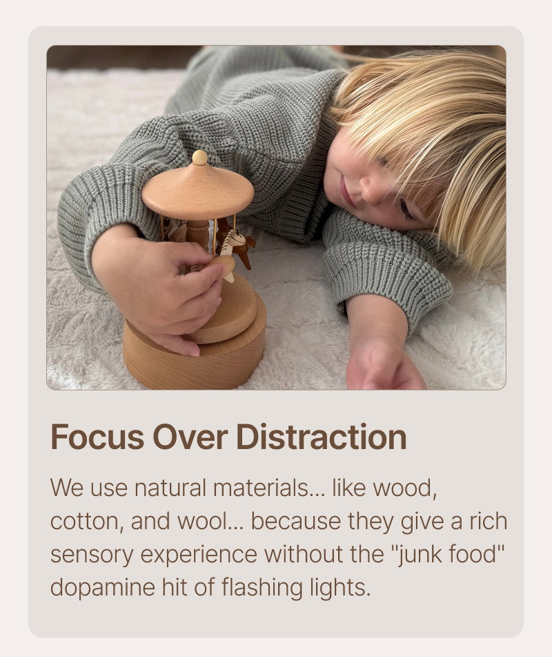Child holding a wooden toy close while resting, accompanied by text about focus over distraction and slower, more intentional play.
