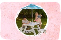 Kids playing on KidKraft picnic table with umbrella