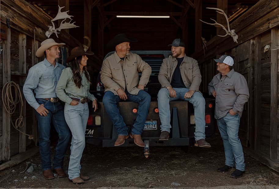 A group of cowboys wearing Justin boots, Justin Jeans and Justin Shirts.