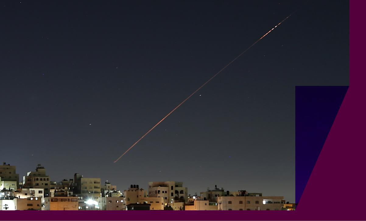 Missiles launched from Iran toward Israel are seen in the sky over the West Bank city of Hebron.