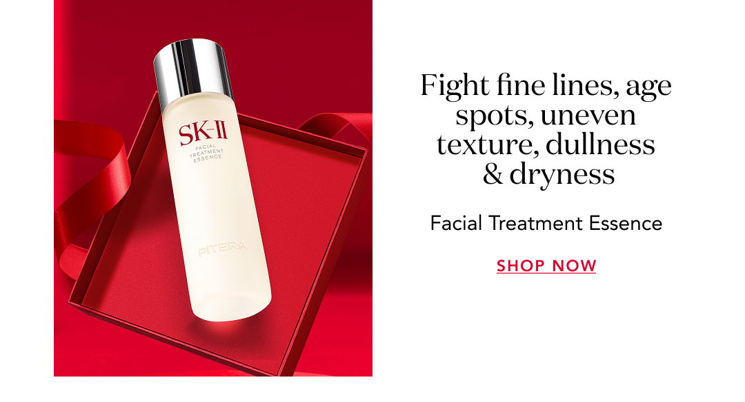 SK-II Facial Treatment Essence bottle displayed on red background with text “Fight fine lines, age spots, uneven texture, dullness & dryness” and “Shop Now.”