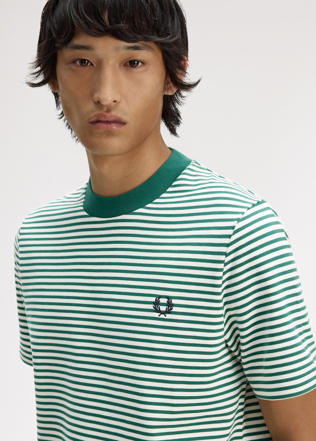 Male model wearing a Fred Perry Fine Stripe Heavyweight T-shirt in Sport Green