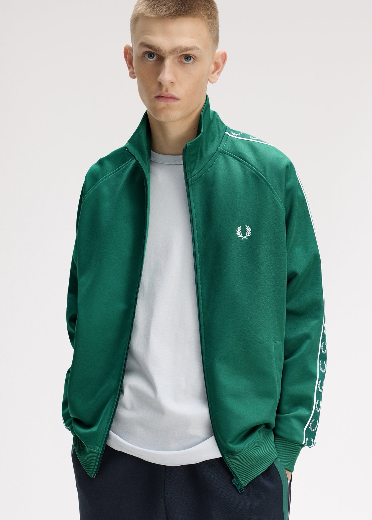 Male model wearing a Fred Perry Contrast Tape Track Jacket in Sport Green