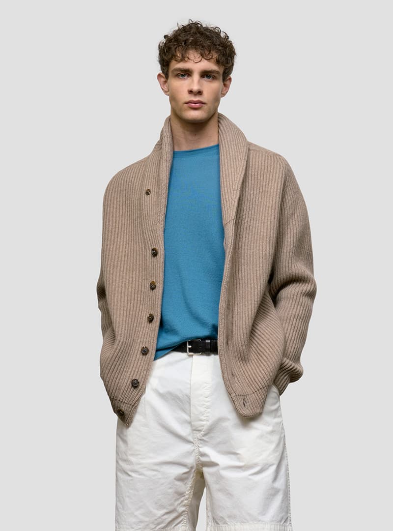 man wearing brown shawl collar cardigan and teal tshirt