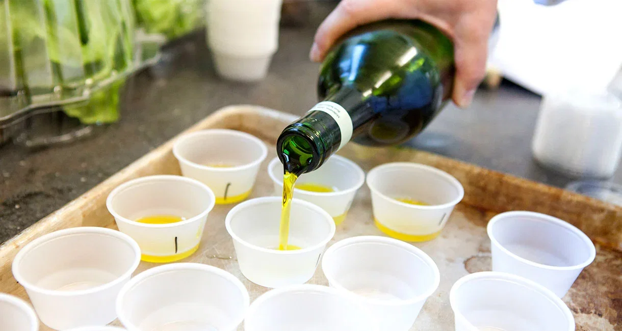 Pouring olive oil into sample cups