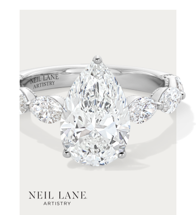 Neil Lane engagement ring with pear-shaped center diamond and marquise side stones.