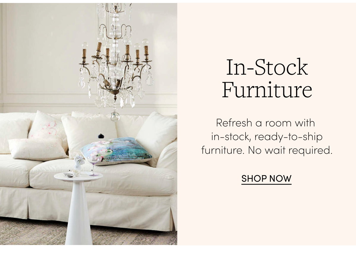 Slipcover sofa with chandelier and side table
