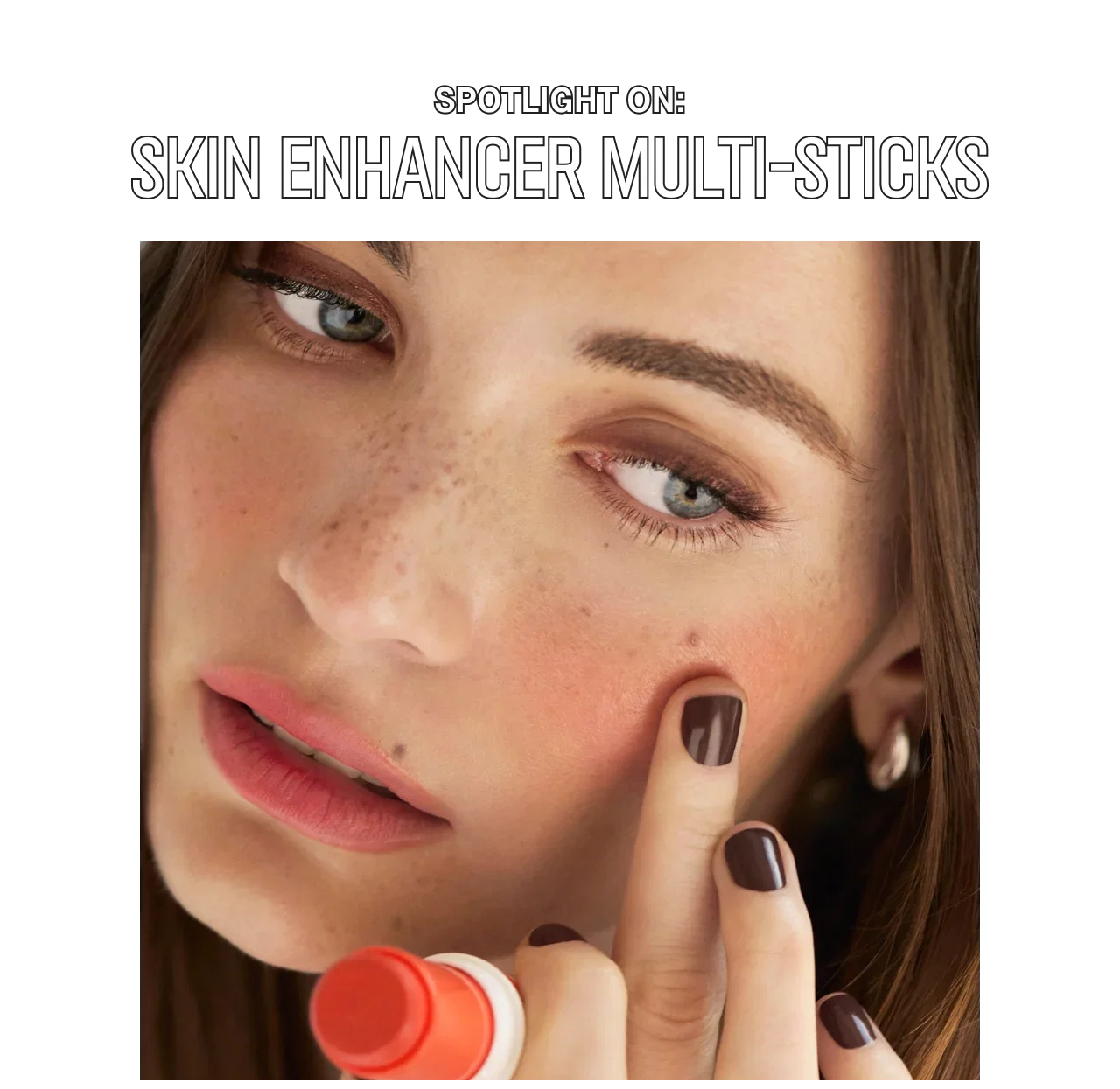 Close-up of a person applying Skin Enhancer Multi-Stick to their cheek, with text above reading, 'Spotlight On: Skin Enhancer Multi-Sticks'.