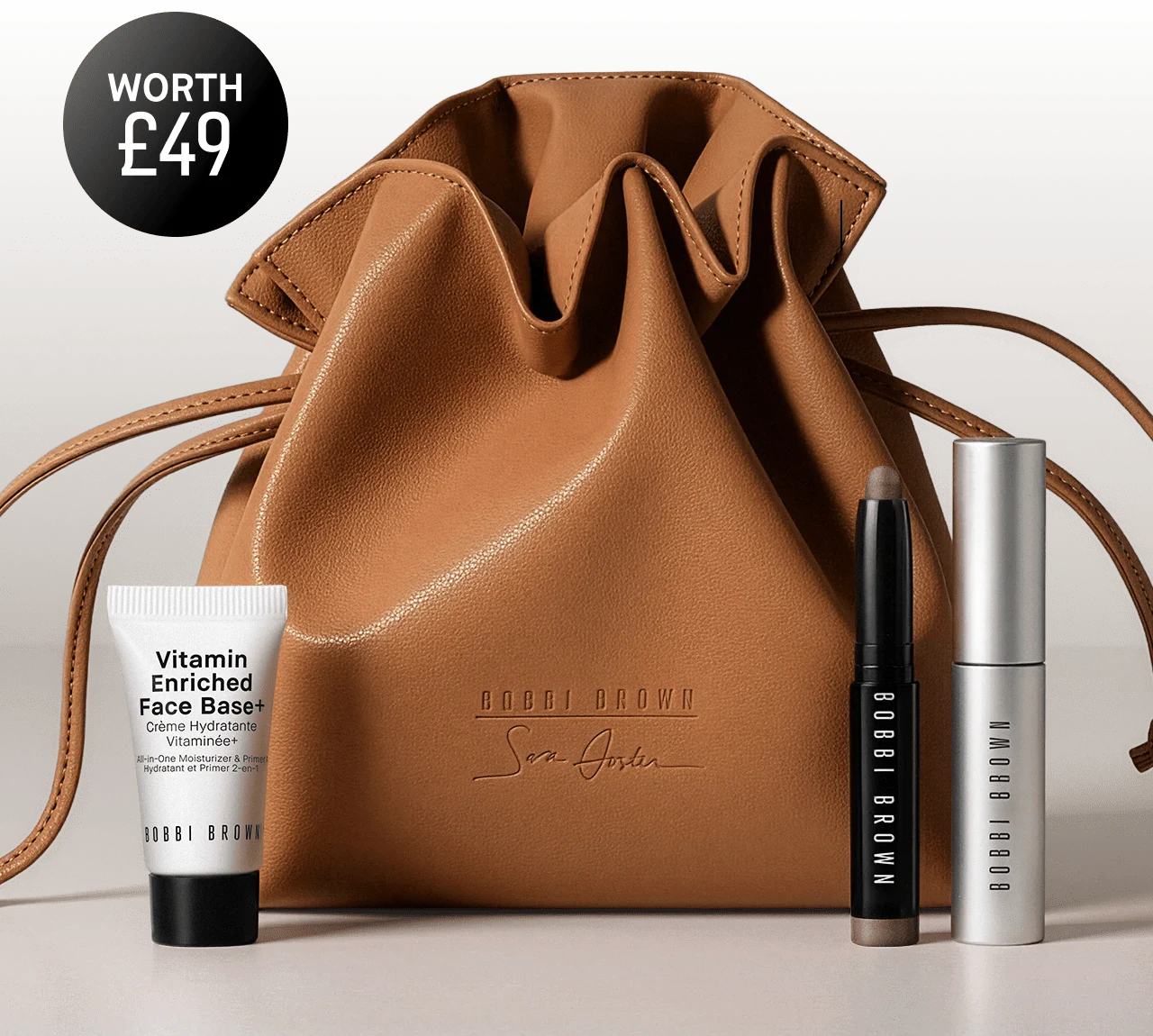 Bobbi Brown cosmetic set with pouch, face base, eye shadow stick, and mascara.