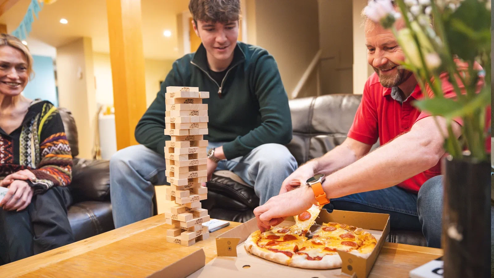 Family enjoying a take away pizza in their lodge
