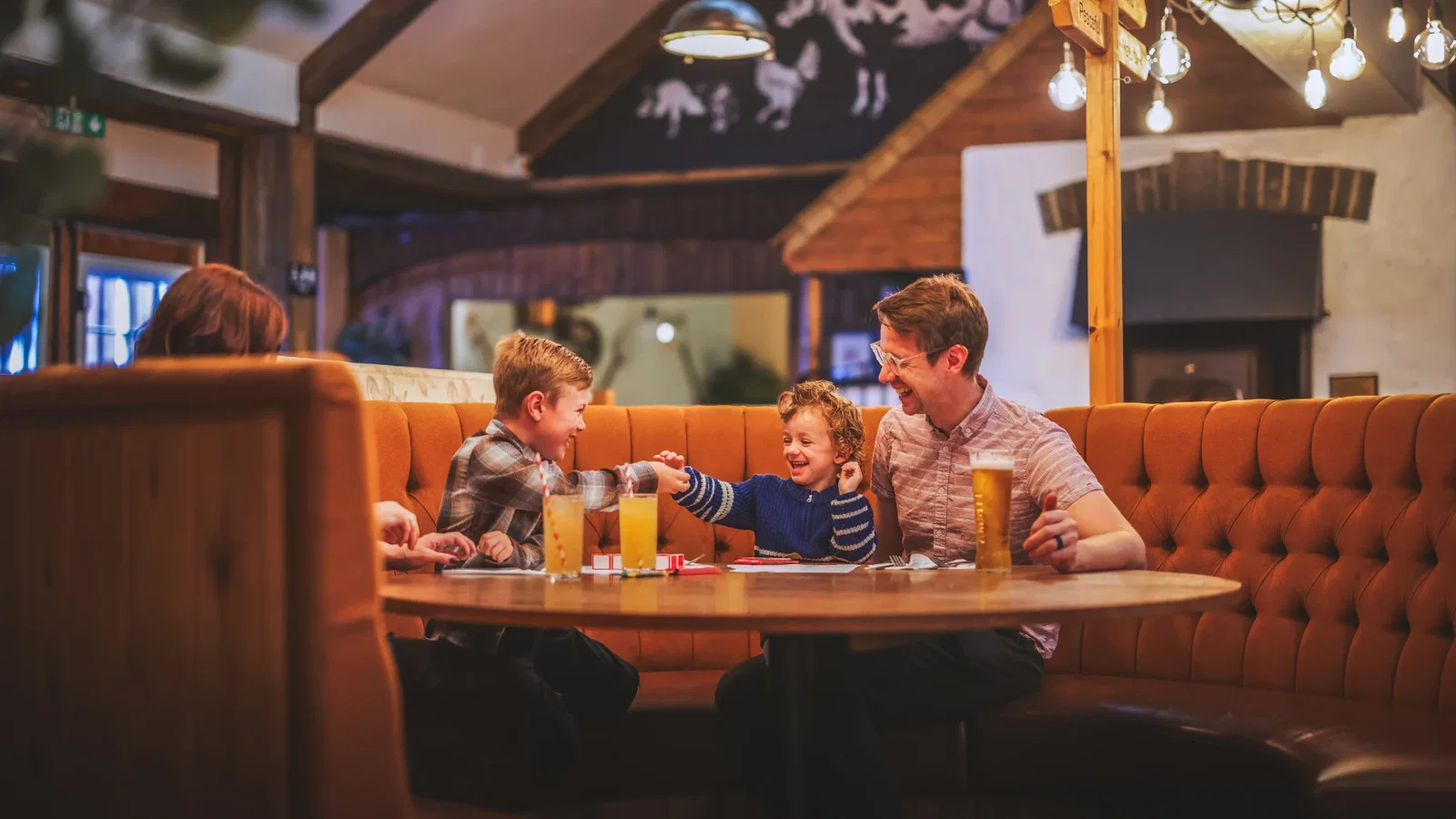 Family enjoying around a table and dining at Bluestone