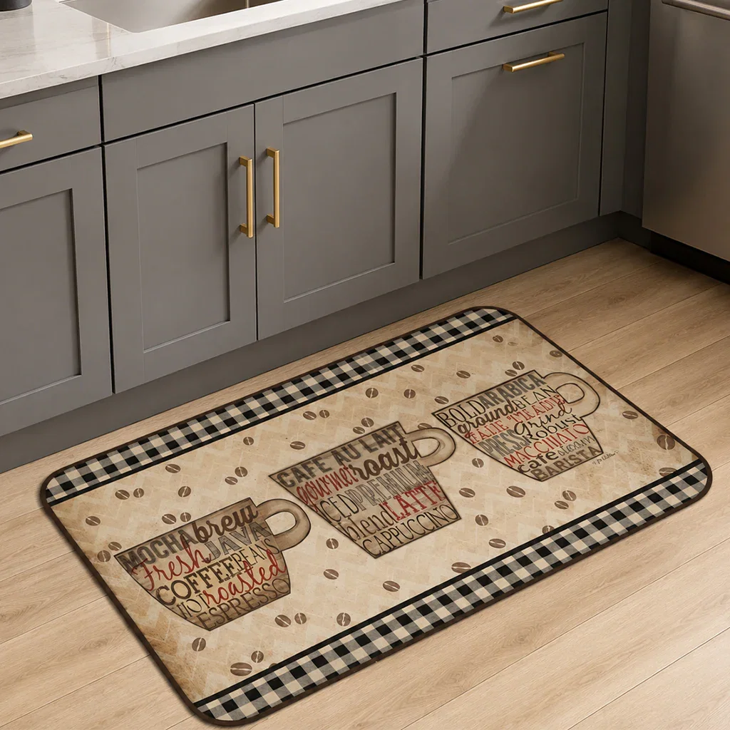 Coffee-themed kitchen mat with gingham border and coffee cup designs on beige background, displayed in modern gray kitchen.
