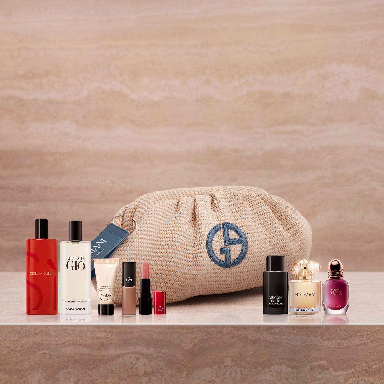 A luxurious lineup of Armani icons featuring Sì, Acqua di Giò, and My Way fragrances, alongside Luminous Silk and an elegant lipstick. Set on marble with a woven beige pouch, this curated collection celebrates high-performance beauty.&ZeroWidthSpace;