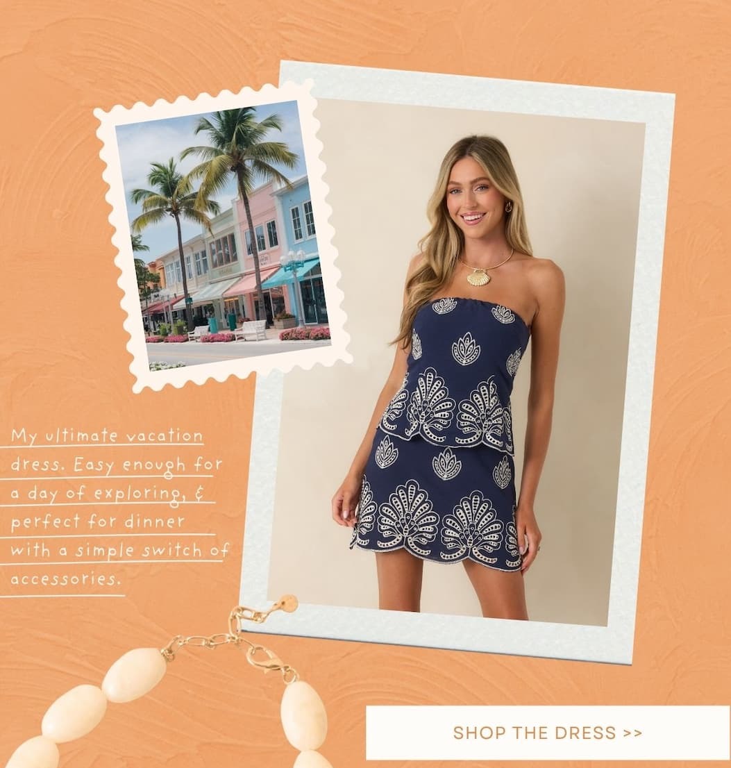 Model wearing a  Navy Embroidered Cotton Strapless Mini Dress. Shop the Dress.