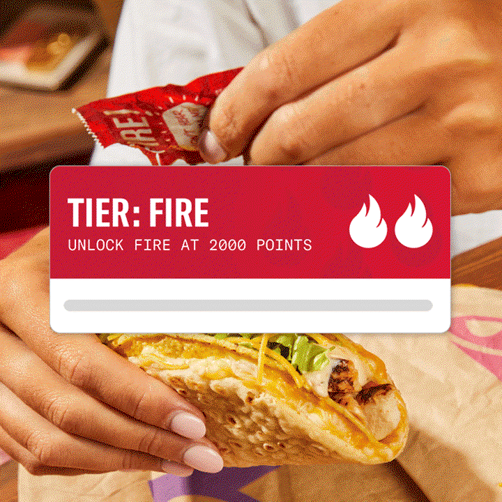 An image of a Taco Bell Tier: Fire banner with a close-up of someone putting Taco Bell Fire Sauce on a Cheesy Gordita Crunch in the background.